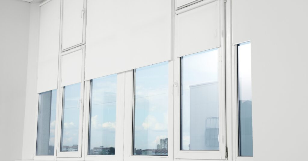 white roller blinds in windows